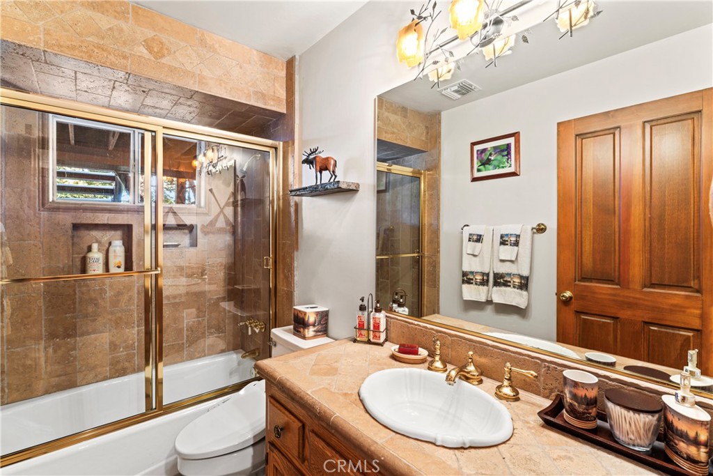 145 Pheasant Run Lake Arrowhead, CA 92352 - Photo 50 of 65 a bathroom with a sink a toilet and shower