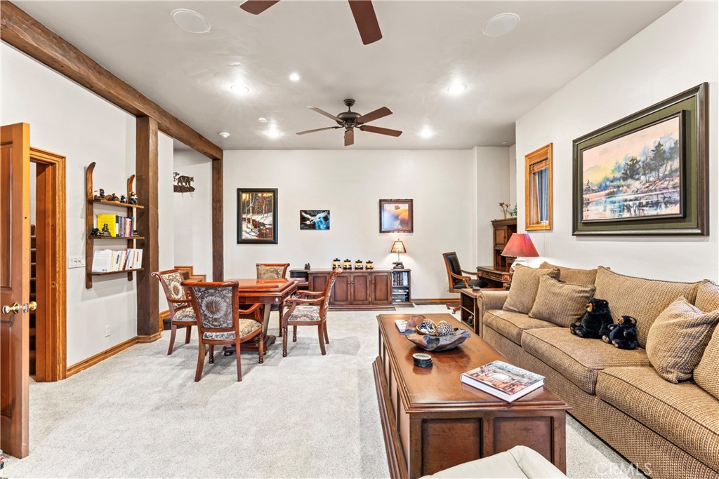 145 Pheasant Run Lake Arrowhead, CA 92352 - Photo 60 of 65 a living room with furniture a chandelier and a dining table