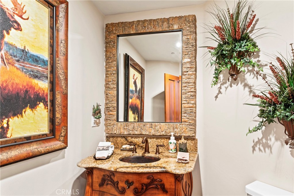 145 Pheasant Run Lake Arrowhead, CA 92352 - Photo 62 of 65 a bathroom with a sink and a mirror