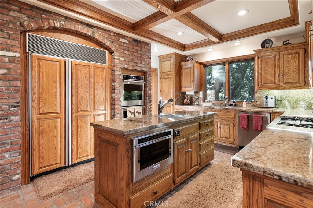 145 Pheasant Run Lake Arrowhead, CA 92352 - Photo 10 of 65 a kitchen with stainless steel appliances granite countertop a stove a sink and a refrigerator