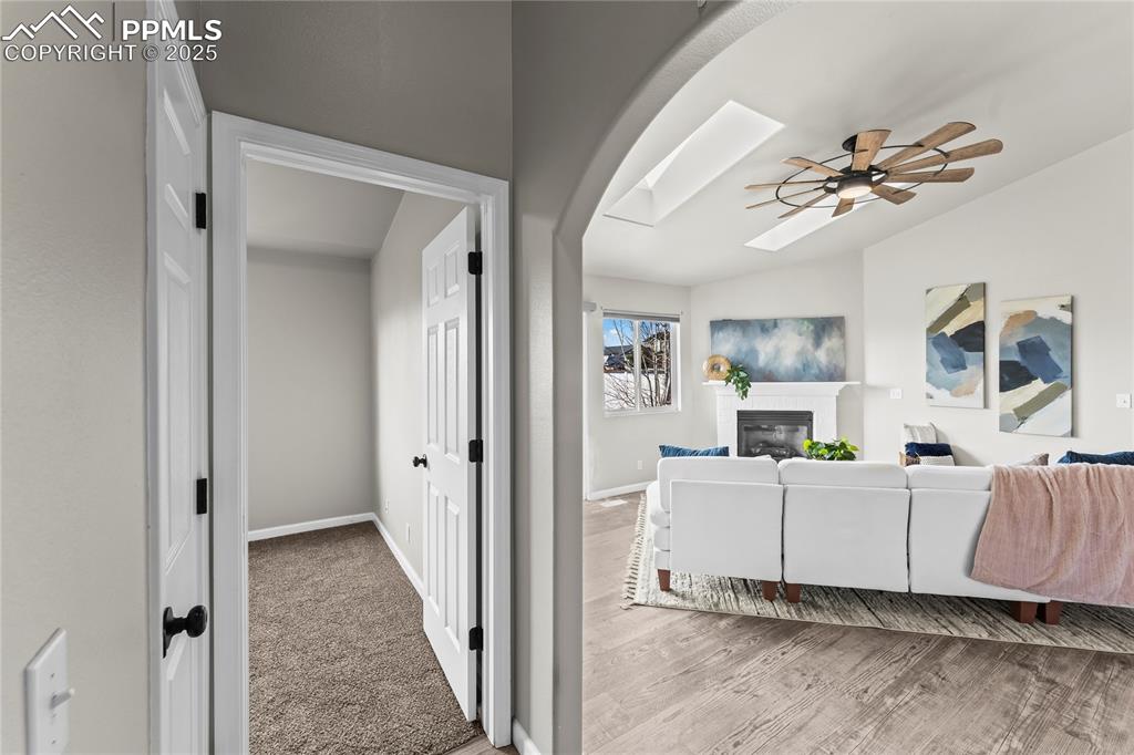 8168 Oliver Road Peyton, CO 80831 - Photo 18 of 42 a view of a livingroom with a flat screen tv ceiling fan and windows