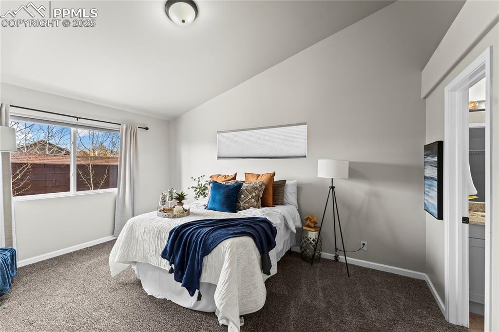 8168 Oliver Road Peyton, CO 80831 - Photo 19 of 42 a bedroom with a bed and glass door