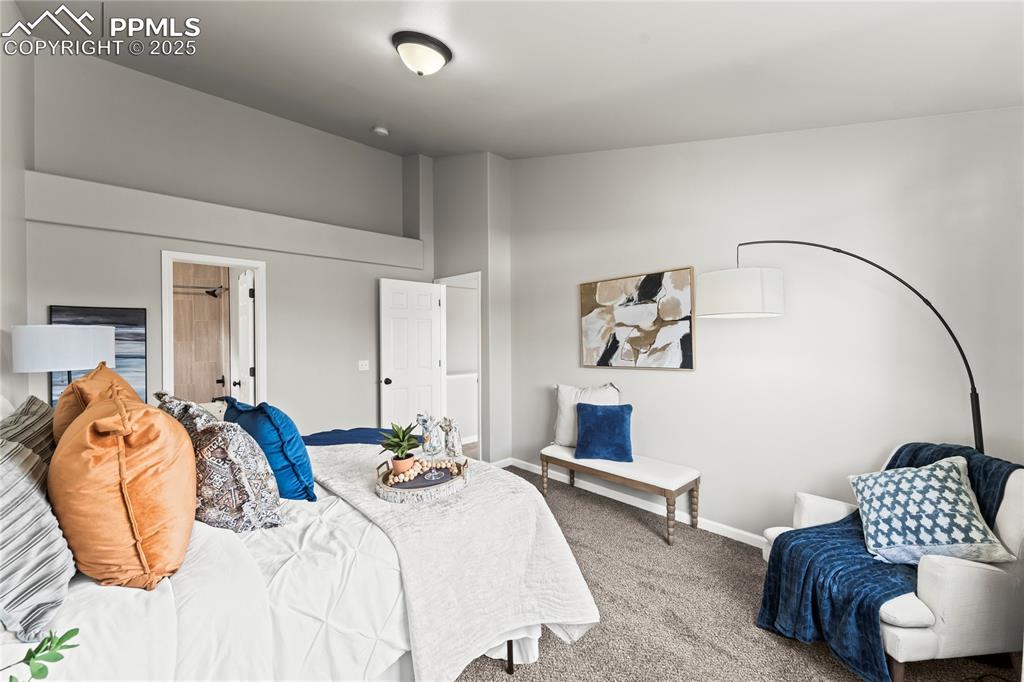 8168 Oliver Road Peyton, CO 80831 - Photo 20 of 42 a bedroom with a bed and wooden floor