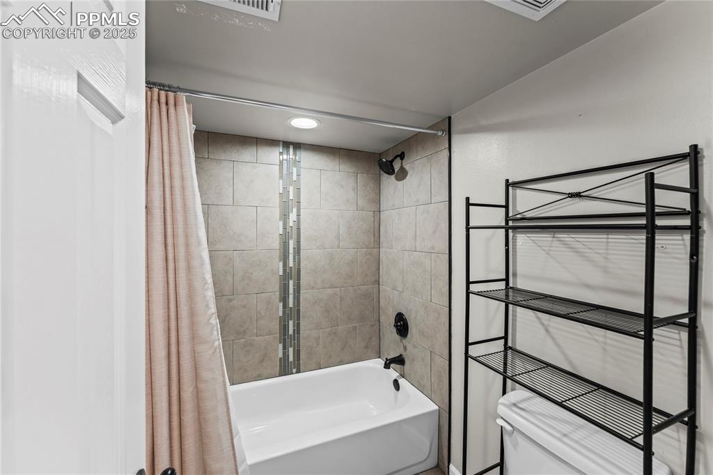 8168 Oliver Road Peyton, CO 80831 - Photo 23 of 42 a bathroom with a shower and a tub