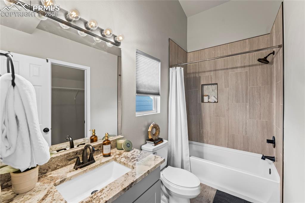 8168 Oliver Road Peyton, CO 80831 - Photo 27 of 42 a bathroom with a granite countertop sink toilet and shower