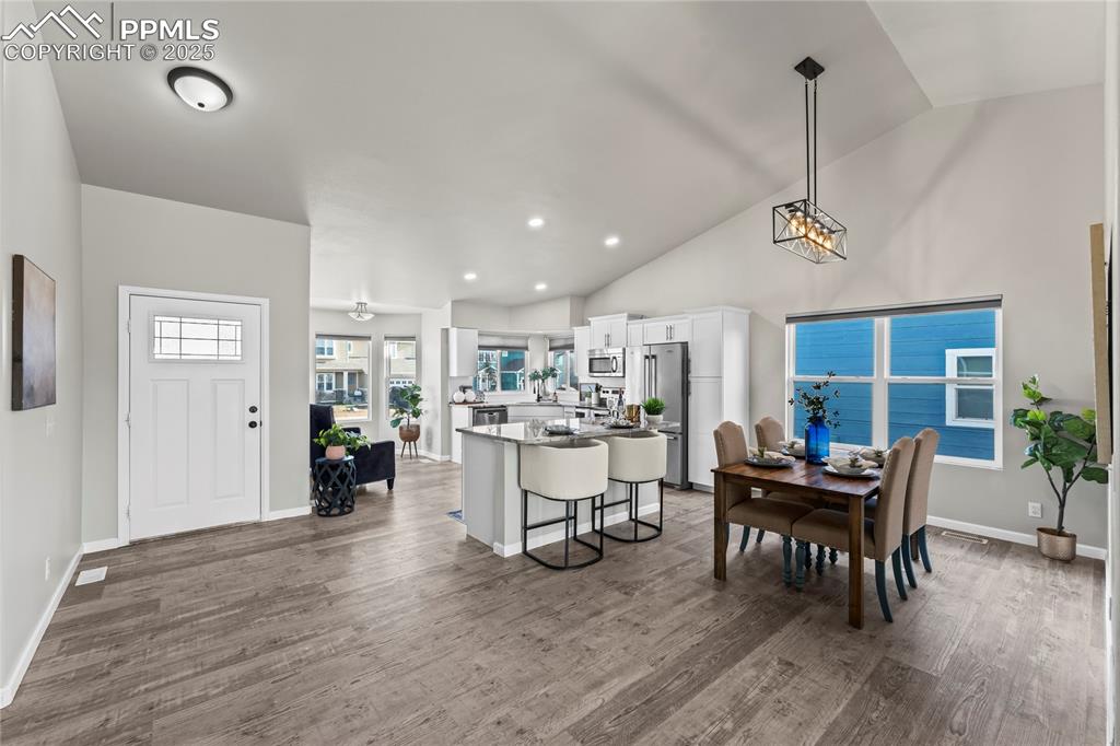 8168 Oliver Road Peyton, CO 80831 - Photo 5 of 42 a view of a dining room with furniture window and wooden floor