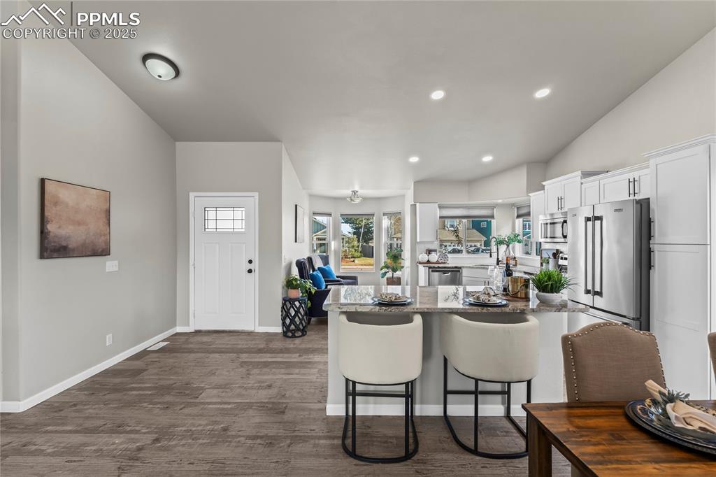 8168 Oliver Road Peyton, CO 80831 - Photo 6 of 42 a living room with stainless steel appliances furniture a dining table and chairs