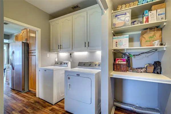 a kitchen with a refrigerator and cabinets