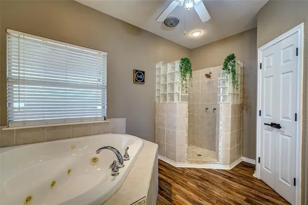 a bathroom with a tub shower and sink