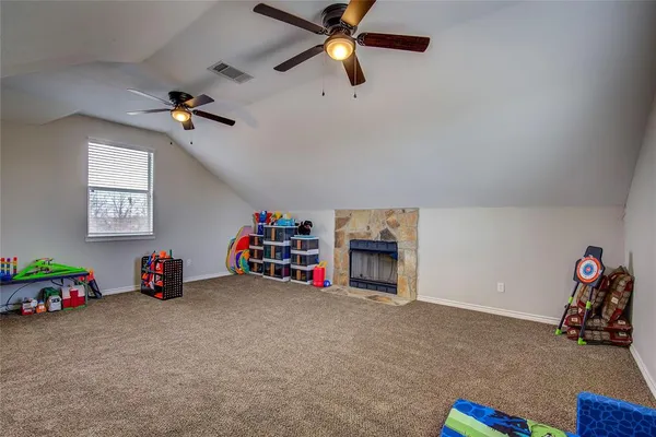 a view of room with toys and a ceiling fan