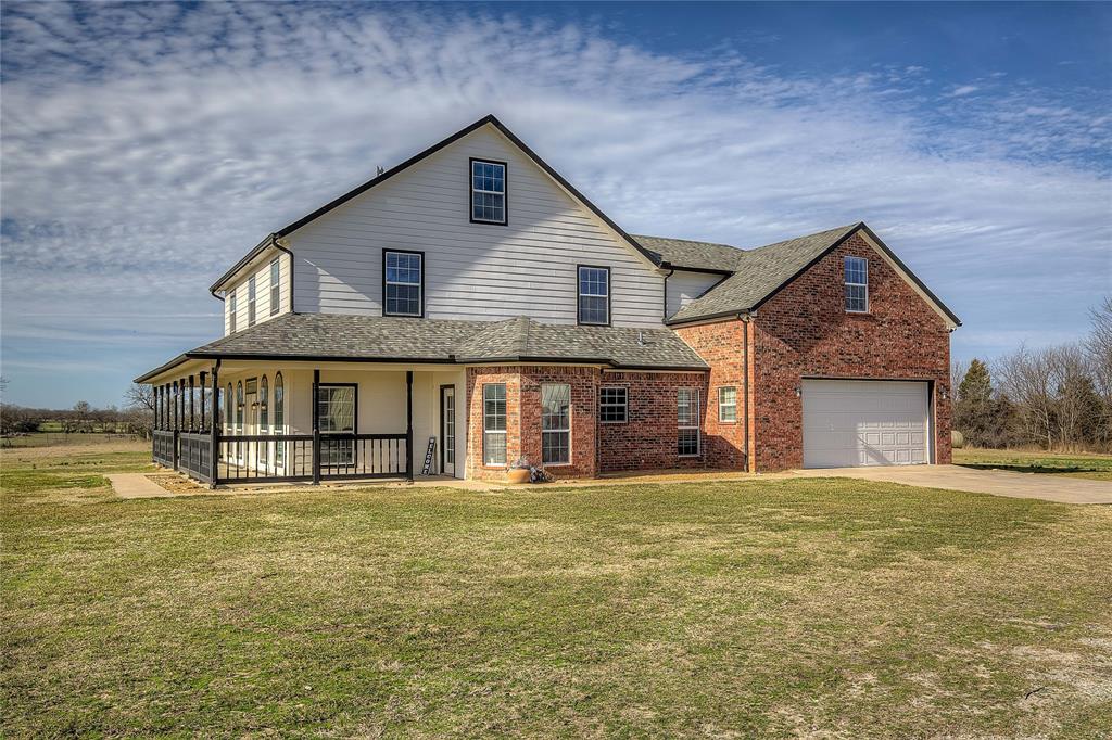 5611 County Road 4705 Commerce, TX 75428 - Photo 2 of 38 a front view of a house with a yard