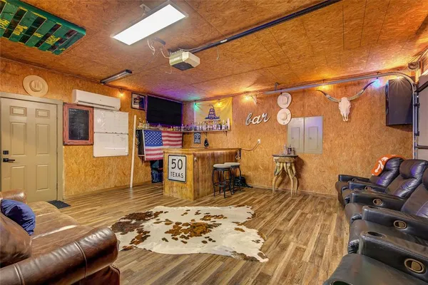 a living room with a couch and a dining table with wooden floor
