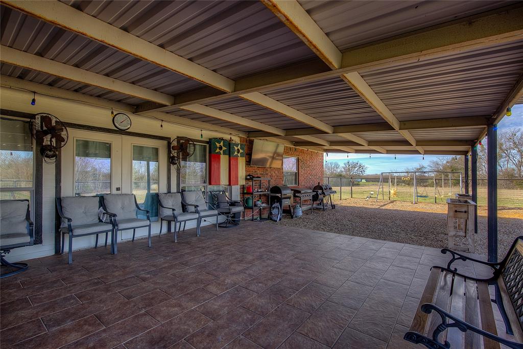 5611 County Road 4705 Commerce, TX 75428 - Photo 28 of 38 a view of a porch with furniture and next to a yard