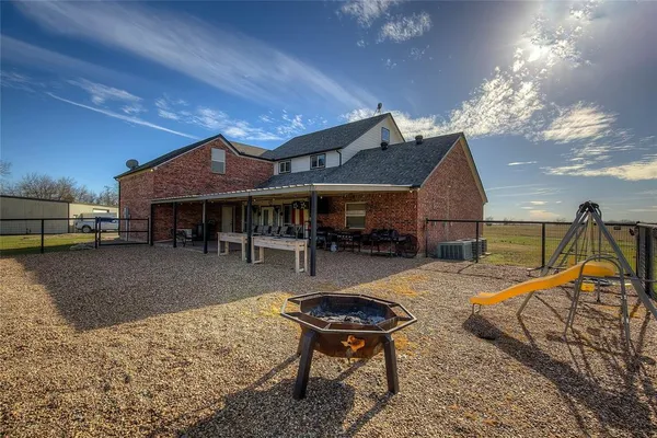 a view of a house with swimming pool and sitting area