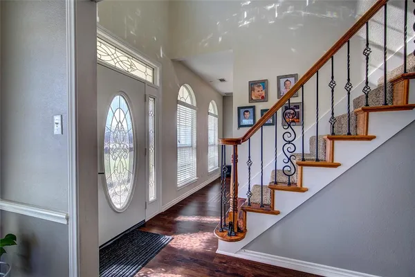 a view of an entryway with wooden floor