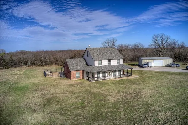 a view of a house with a yard and sitting area