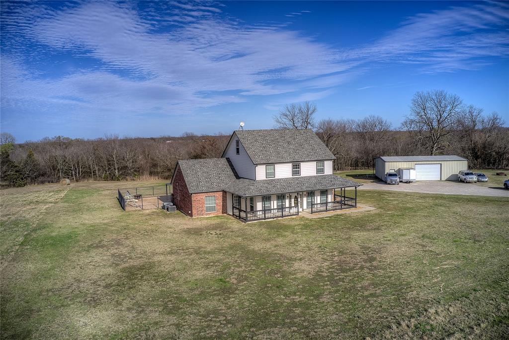 5611 County Road 4705 Commerce, TX 75428 - Photo 34 of 38 a view of a house with a yard and sitting area