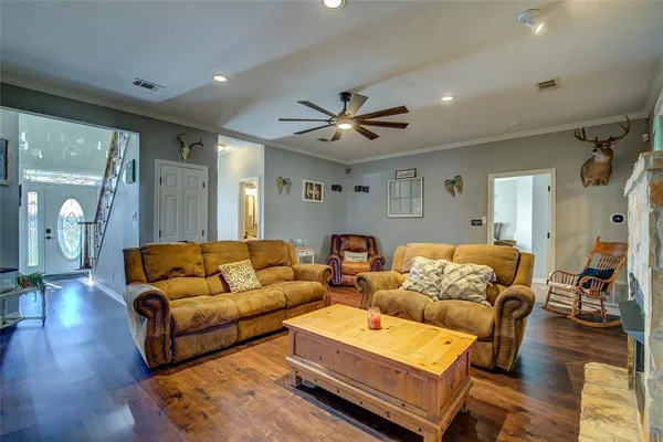 a living room with furniture and wooden floor