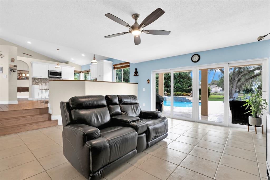 14809 Southwest 154th Court Miami, FL 33196 - Photo 14 of 30 a living room with furniture and a large window with kitchen view