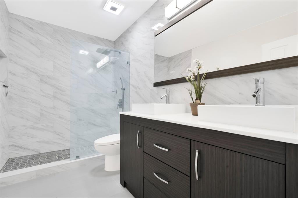 14809 Southwest 154th Court Miami, FL 33196 - Photo 21 of 30 a bathroom with a double vanity sink toilet and a mirror
