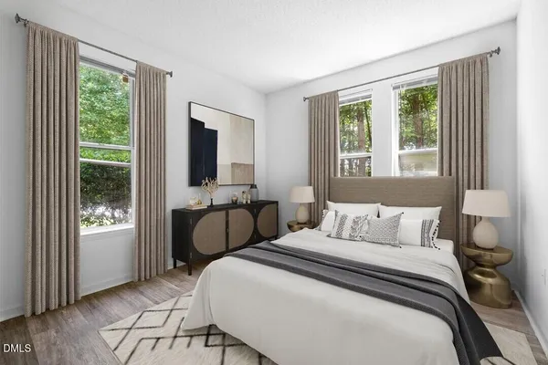 a bedroom with a bed and a large window