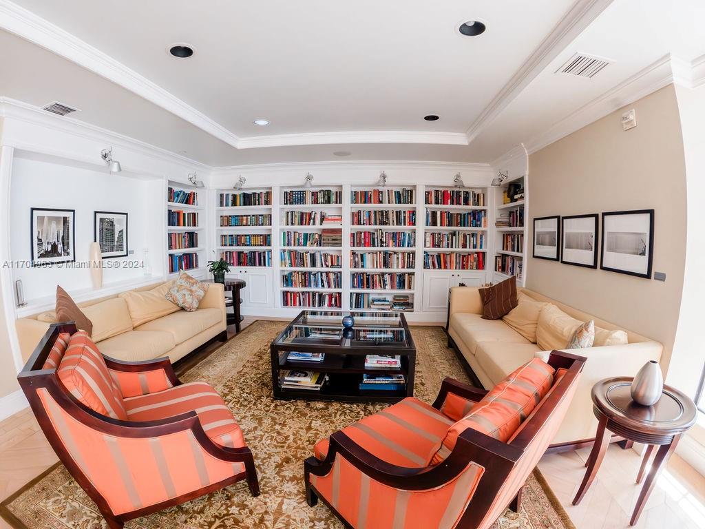 233 South Federal Highway, Unit 723 Boca Raton, FL 33432 - Photo 12 of 35 a living room with furniture a rug and a book shelf