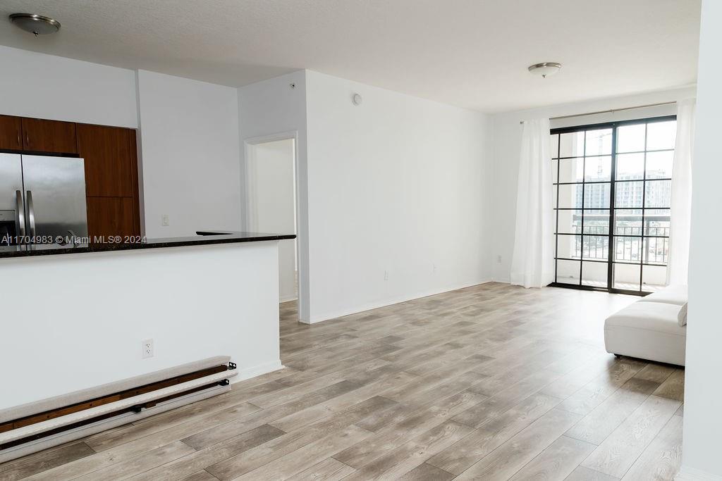 233 South Federal Highway, Unit 723 Boca Raton, FL 33432 - Photo 17 of 35 a view of an empty room with a window and wooden floor