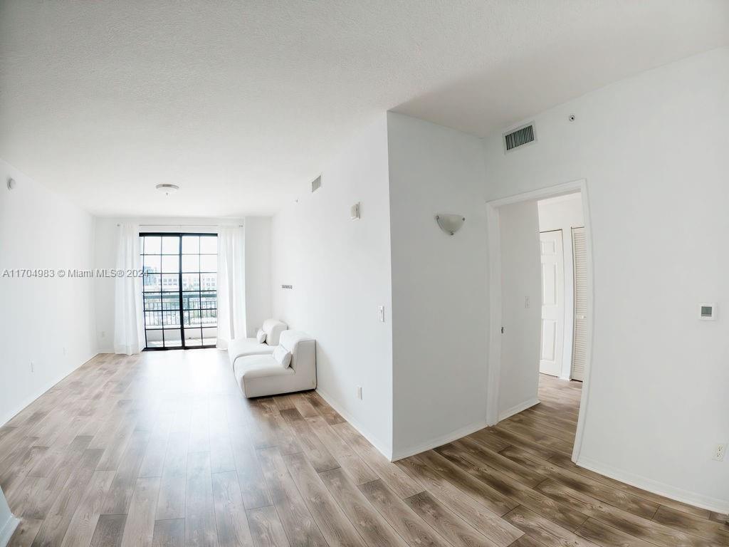 233 South Federal Highway, Unit 723 Boca Raton, FL 33432 - Photo 18 of 35 a hallway with wooden floor and furniture