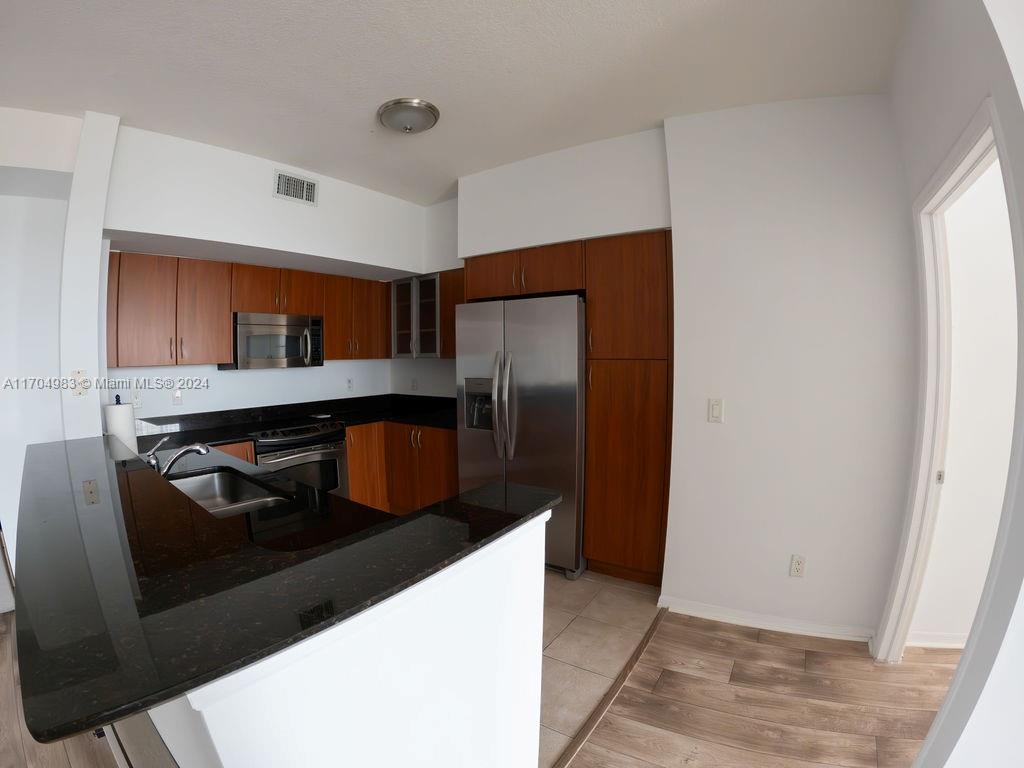 233 South Federal Highway, Unit 723 Boca Raton, FL 33432 - Photo 19 of 35 a kitchen with stainless steel appliances granite countertop a refrigerator and a stove