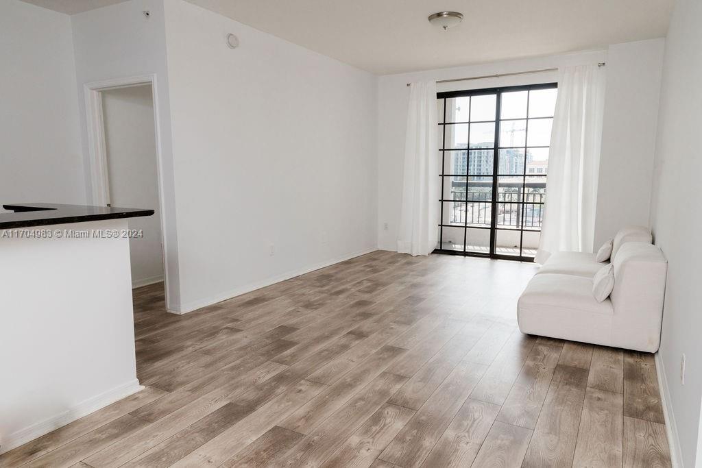 233 South Federal Highway, Unit 723 Boca Raton, FL 33432 - Photo 23 of 35 a view of an empty room with wooden floor and a window