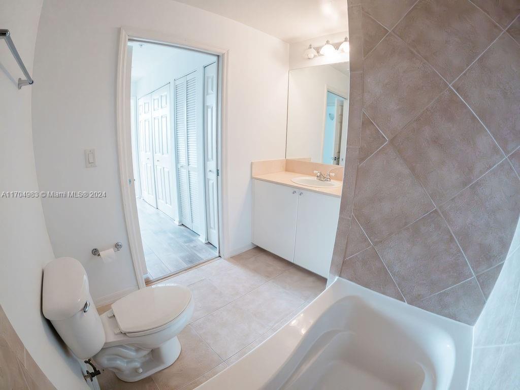 233 South Federal Highway, Unit 723 Boca Raton, FL 33432 - Photo 27 of 35 a bathroom with a granite countertop sink a toilet and shower