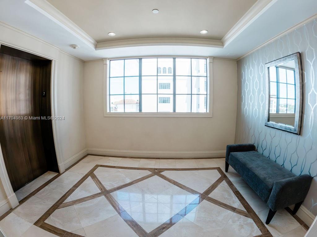 233 South Federal Highway, Unit 723 Boca Raton, FL 33432 - Photo 5 of 35 a living room with a couch a window and a flat screen tv