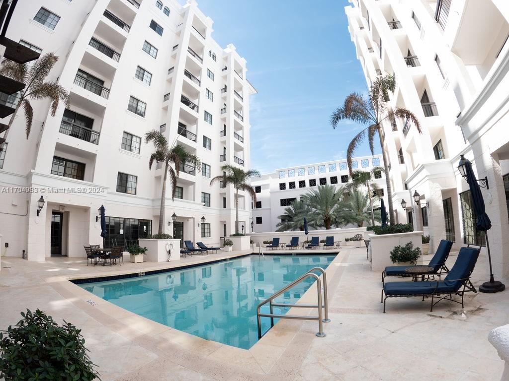 233 South Federal Highway, Unit 723 Boca Raton, FL 33432 - Photo 7 of 35 a view of a swimming pool with outdoor seating and buildings