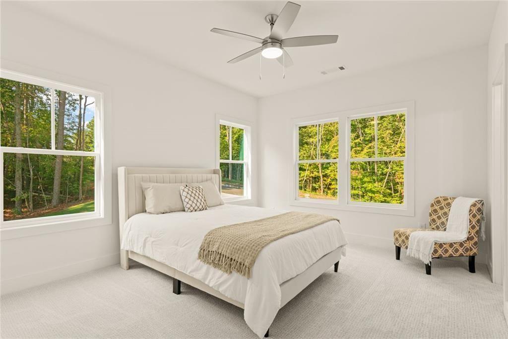 240 Highlands Ball Ground, GA 30107 - Photo 40 of 57 a bedroom with a bed couches and two windows