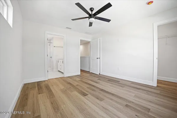 a view of empty room with wooden floor
