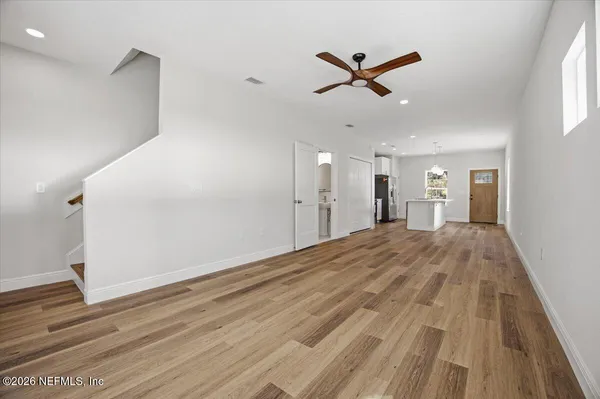 a view of a livingroom with a hardwood floor and a ceiling fan
