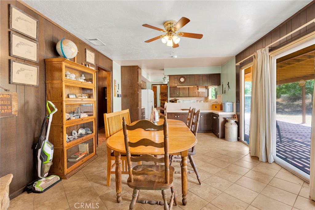 5500 Oil Well Road Phelan, CA 92371 - Photo 12 of 65 a view of a dining room with furniture a chandelier and a flat screen tv