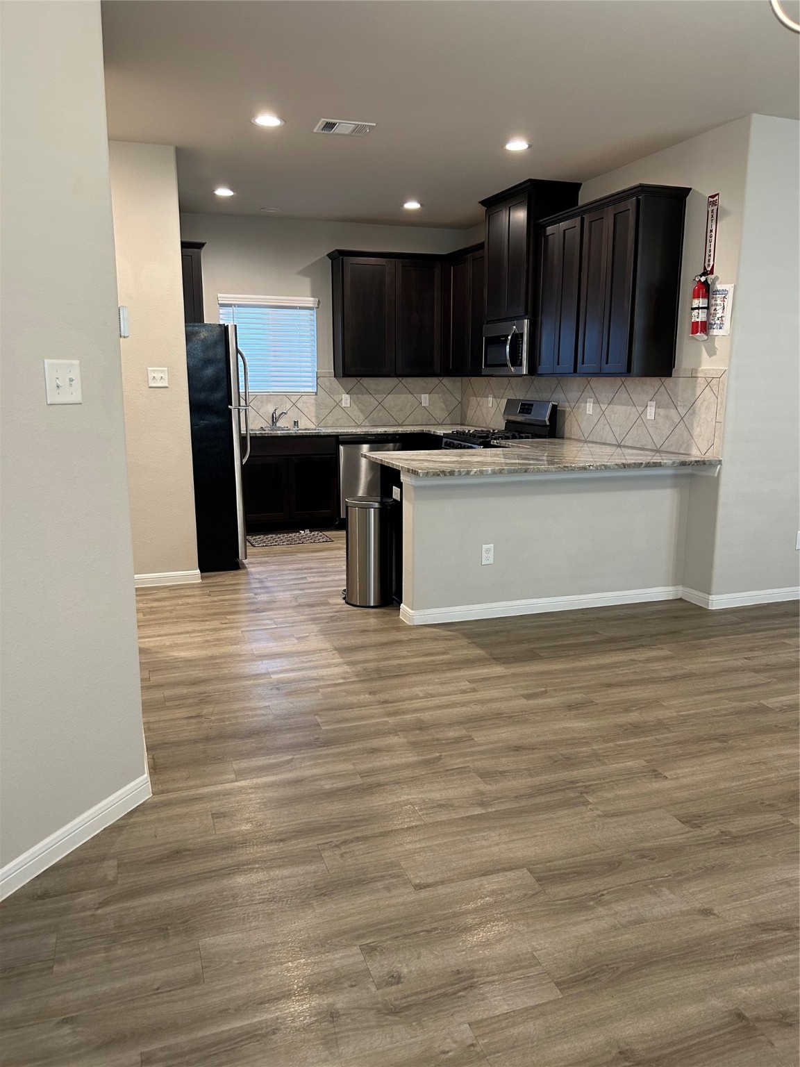 6511 Wenlock Drive Houston, TX 77048 - Photo 2 of 23 a kitchen with stainless steel appliances granite countertop a sink a stove and a microwave oven