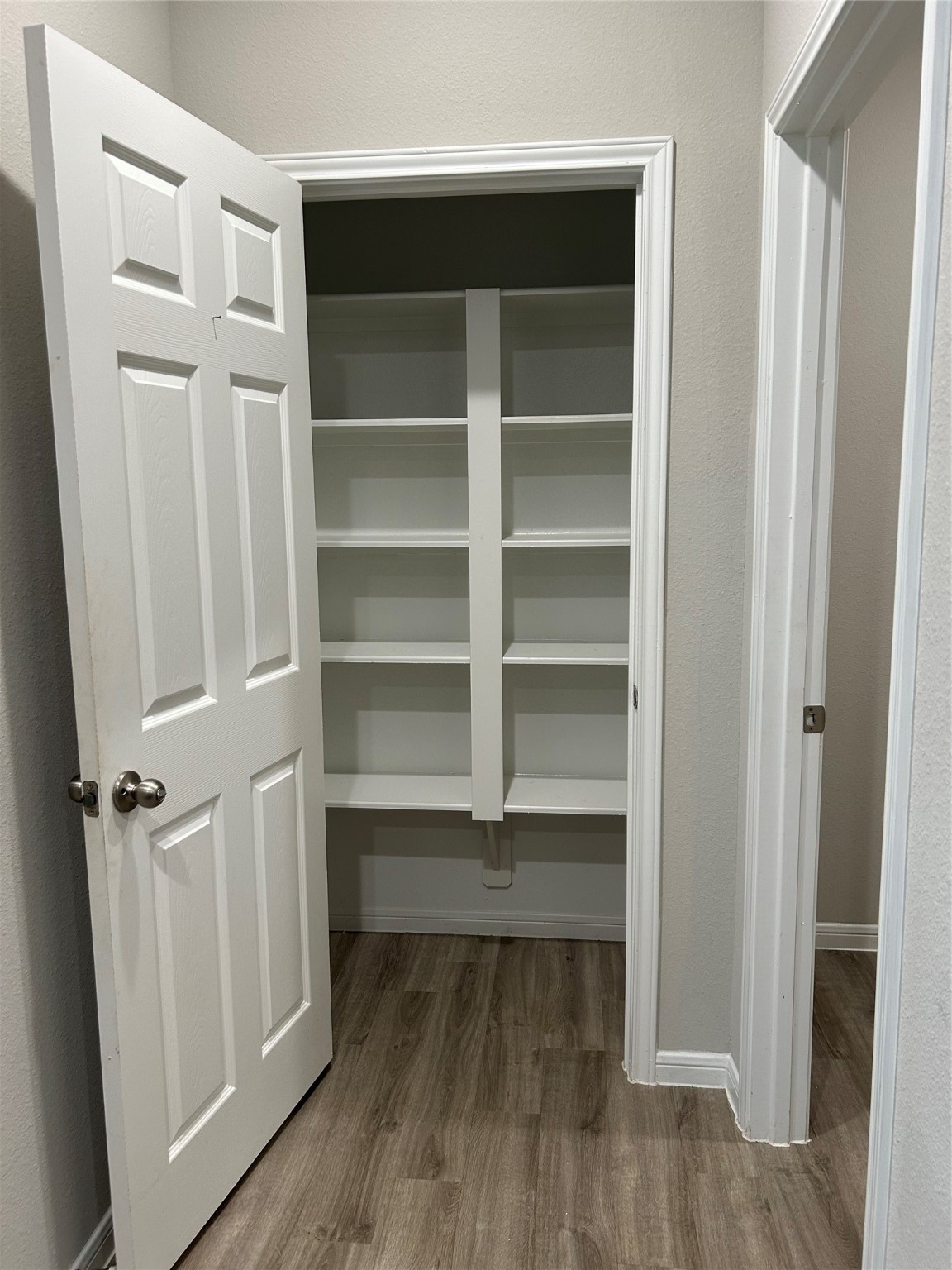 6511 Wenlock Drive Houston, TX 77048 - Photo 8 of 23 a view of walk in closet with empty racks