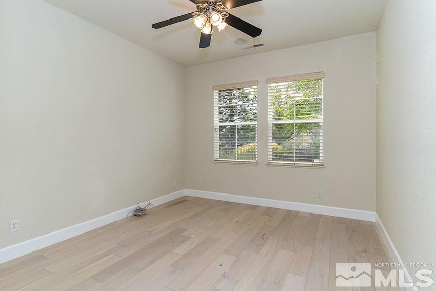8170 Willow Ranch Trail Reno, NV 89523 - Photo 11 of 23 an empty room with wooden floor and windows