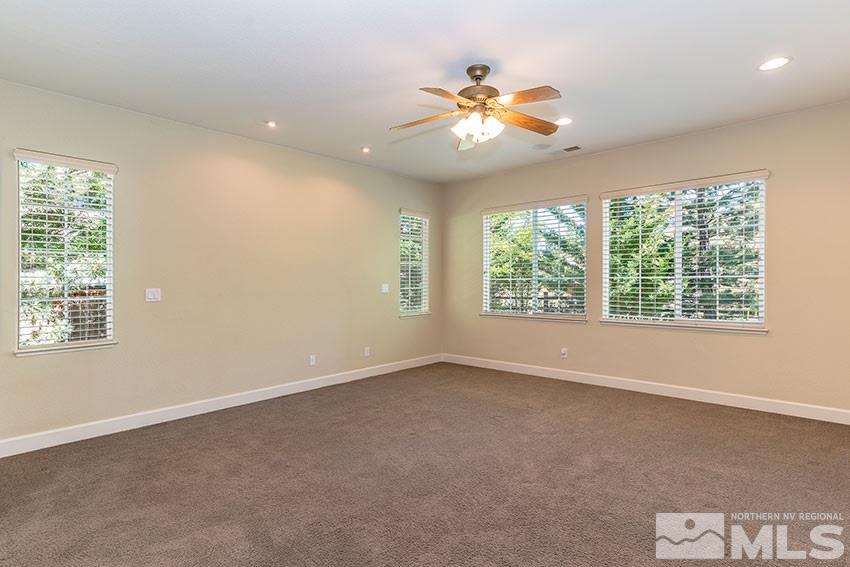 8170 Willow Ranch Trail Reno, NV 89523 - Photo 14 of 23 an empty room with windows and chandelier fan