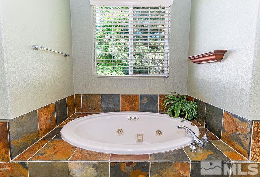 8170 Willow Ranch Trail Reno, NV 89523 - Photo 16 of 23 a bath tub sitting in a bathroom next to a window