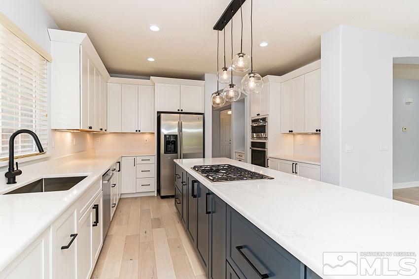 8170 Willow Ranch Trail Reno, NV 89523 - Photo 6 of 23 a kitchen with stainless steel appliances granite countertop a sink stove and refrigerator