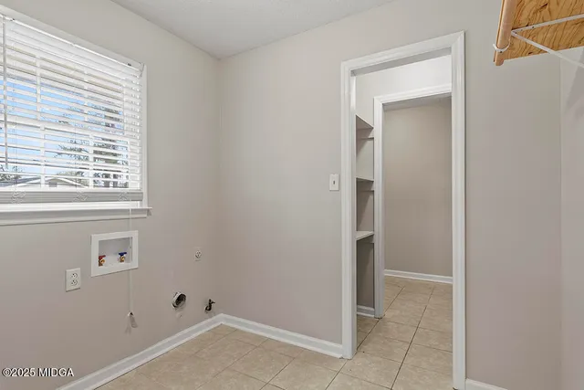 a kitchen with granite countertop white cabinets and stainless steel appliances