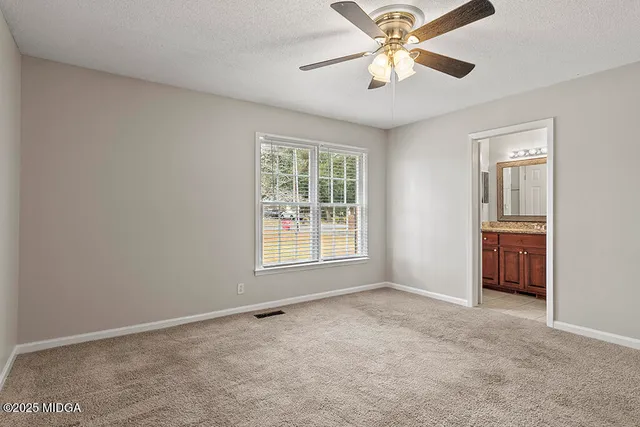 a bathroom with a granite countertop sink mirror toilet and bathtub