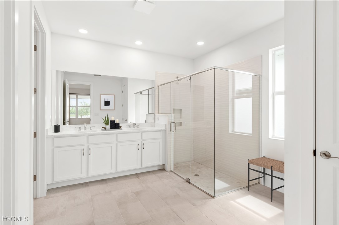 16236 Wax Myrtle Street Punta Gorda, FL 33982 - Photo 13 of 37 a spacious bathroom with a double vanity sink mirror and double