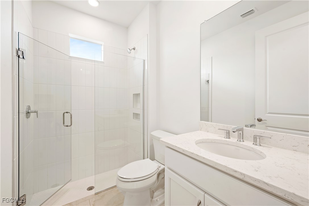 16236 Wax Myrtle Street Punta Gorda, FL 33982 - Photo 18 of 37 a bathroom with a sink toilet and shower