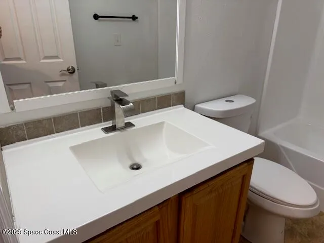a bathroom with a sink a toilet and a tub
