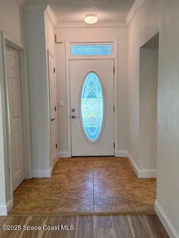a view of a room with wooden floor and white walls