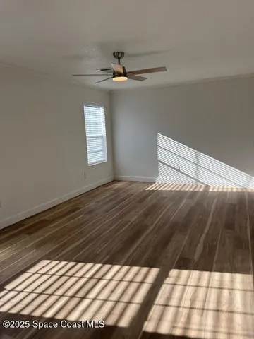a view of a room with wooden floor